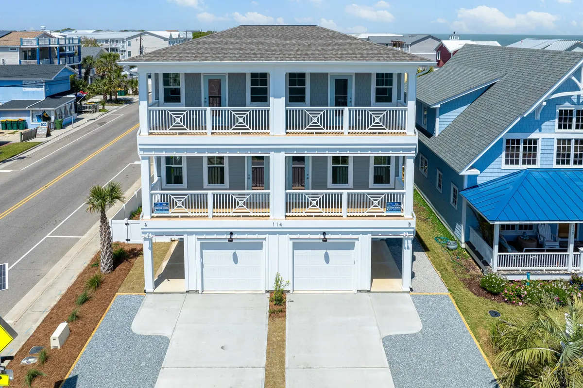 An exterior shot of a three-story home with balconies and palm trees in the foreground, set in a cheerful, sunlit neighborhood. The property’s inviting facade, ample outdoor spaces, and visible community suggest the potential for social gatherings, easy neighborhood exploration, and a welcoming central base for group adventures.